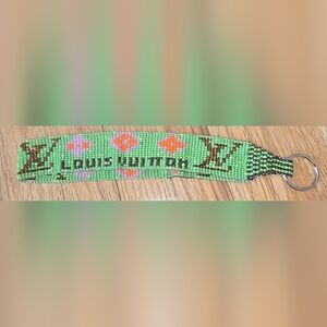 Green Beaded Bracelet with Orange and Pink Accents